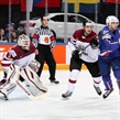 PRAGUE, CZECH REPUBLIC - MAY 12: Latvia's Edgars Maslaskis #31 looks on as teammate Krisjanis Redlihs #9 battles with France's Teddy da Costa #80 during preliminary round action at the 2015 IIHF Ice Hockey World Championship. (Photo by Andre Ringuette/HHOF-IIHF Images)

